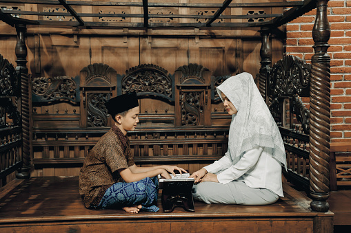 A Malay Muslim Mother Teaches Her Son To Read the Quran at  joglo house