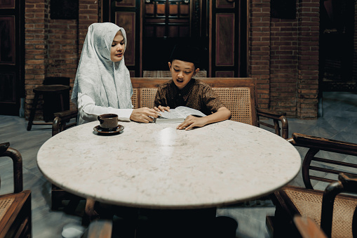 A Malay Muslim Mother Teaches Her Son To Read the Quran at  joglo house