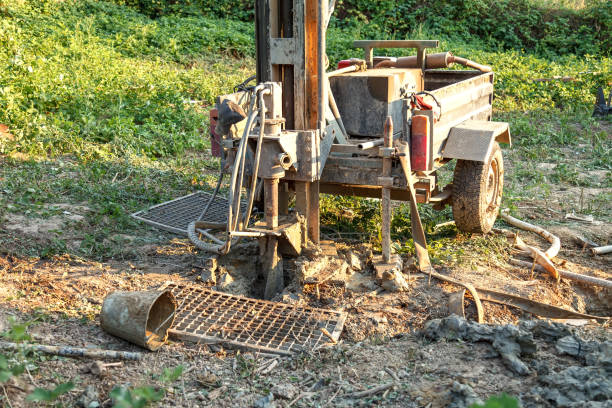 Rotary drilling rig at a construction site.Sludge flow from the joule during the water well drilling Drilling rig for drilling water wells and producing drinking water for residential premises. Pumping dirty water out of the well joule stock pictures, royalty-free photos & images