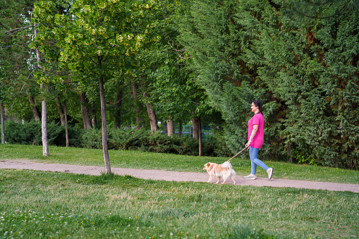 Young woman with her dog in a park