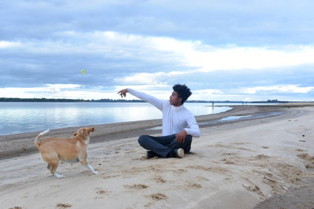 istock young man with pet on the river bank 1499242281