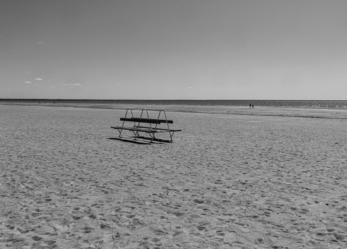 A lonely bench on the sandy beach