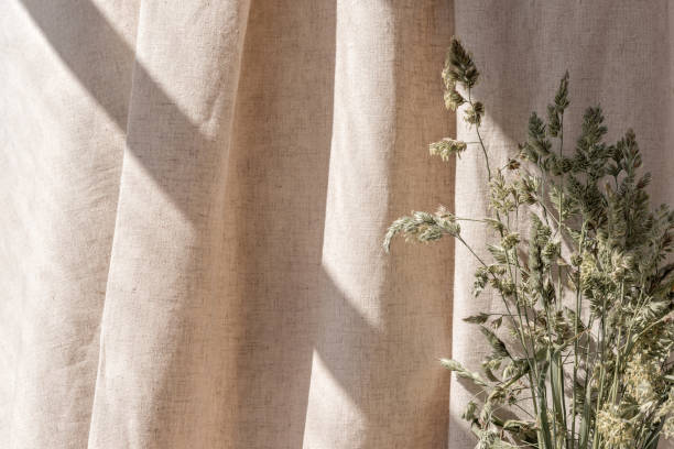 istock Aesthetic boho neutral floral background, abstract sunlight shadows on beige linen curtain and meadow grass, elegant business, interior or wedding design template 1499245481