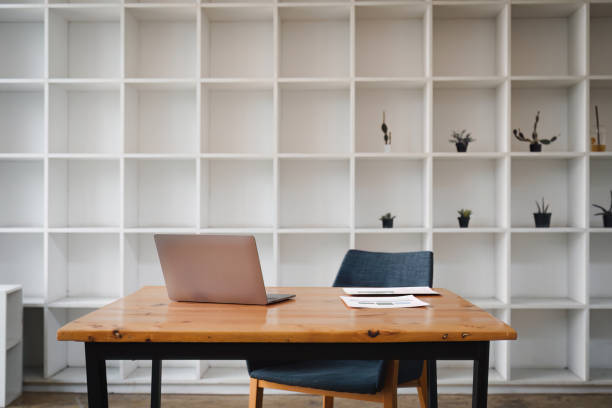 istock Front view laptop on wooden table at office. Financial document paper report on table. In modern office workplace 1499246679
