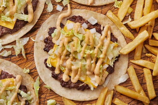 Preparing The Viral Big M Smash Burger Taco with American Cheese, Pickles, Onions, Lettuce, Secret Sauce and Fries