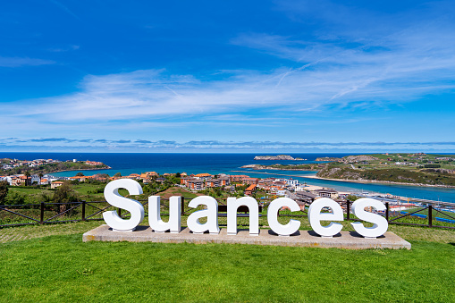 Suances sign letters with aerial skyline view and sea in Cantabria in north Spain