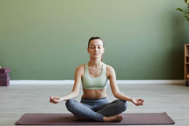 istock Smiling young woman meditating with eyes closed 1499253524