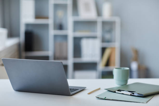 istock Background image of open laptop on desk at office workplace 1499253563