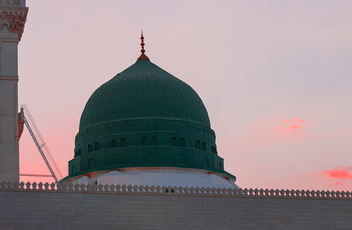 Al-Masjid An-Nabawi - The Prophet Mosque. Sunset at Medina. The famous Green Dome. Iftar time for Ramadan