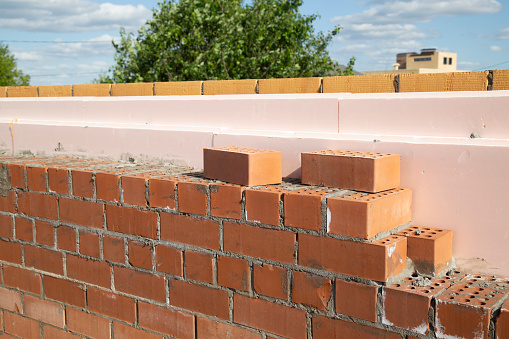 Laying bricks. Construction of a new house.Construction of a brick house.