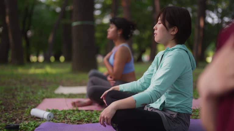 Portrait of female yoga participant during yoga class in nature