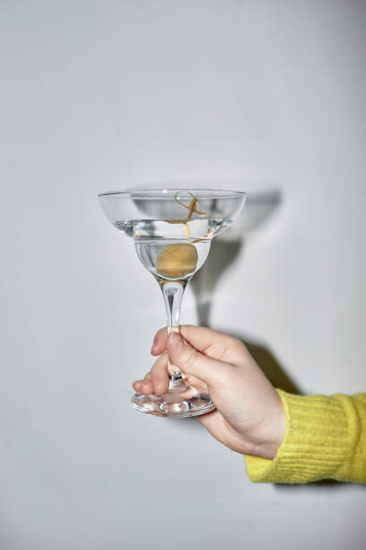 istock Woman holding martini glass during party with flash 1499256640