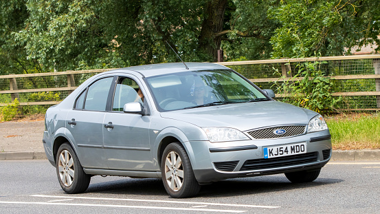 Milton Keynes,UK - June 18th 2023: 2004 silver FORD MONDEO car travelling on an English road