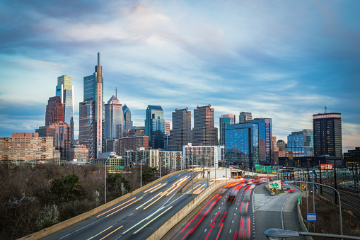 A skyline shot of Philadelphia taken at dusk.  It was a peaceful and warm spring evening with the traffic of light streaks zooming through.