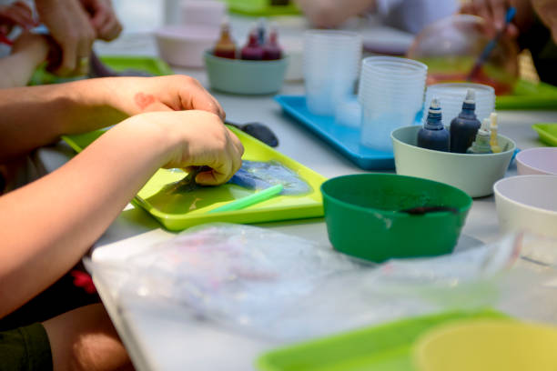 istock A young hand draws clear mucus from a cup. Chemical experiments. 1499264429