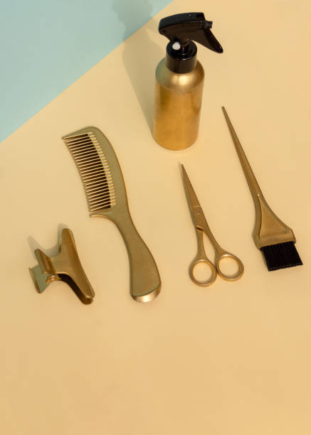 istock Creative vertical banner with gold colored barber tools. Hair salon accessories on yellow background, top view, flat lay. 1499269729