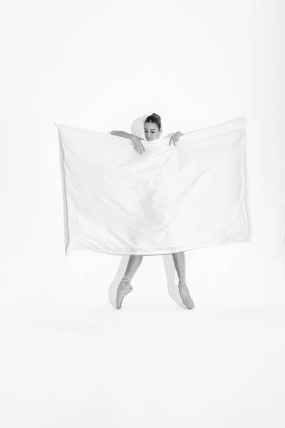 Ballerina behind white fabric textile