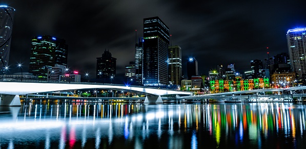An illuminated landscape of sparkling lights over a body of water: Brisbane city