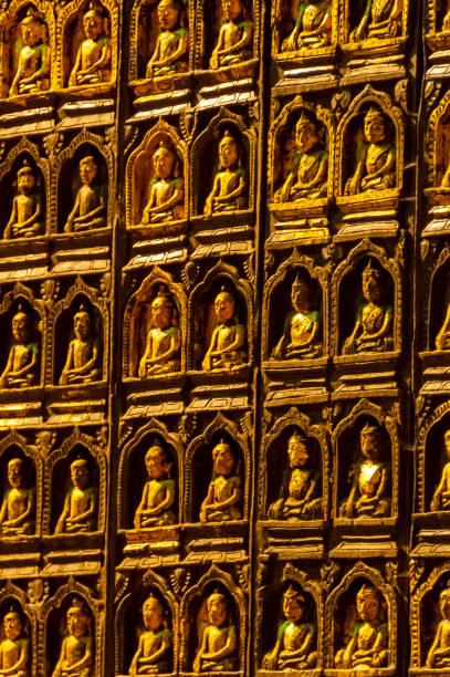 Pindaya, Shan State, Myanmar - nov 8, 2012: hinside the Pindaya Caves, a large portal is decorated with dozens of small Buddha statues covered with pure gold leaf