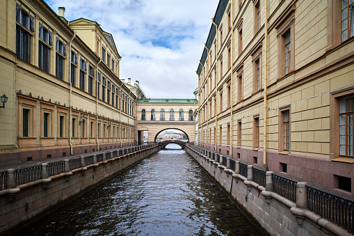 Cityscape of the Zimnyaya Kanavka Canal ( Canal Connecting Neva And Moika Rivers) in cloudy day, old residential buildings in the historical center of St. Petersburg, Russia