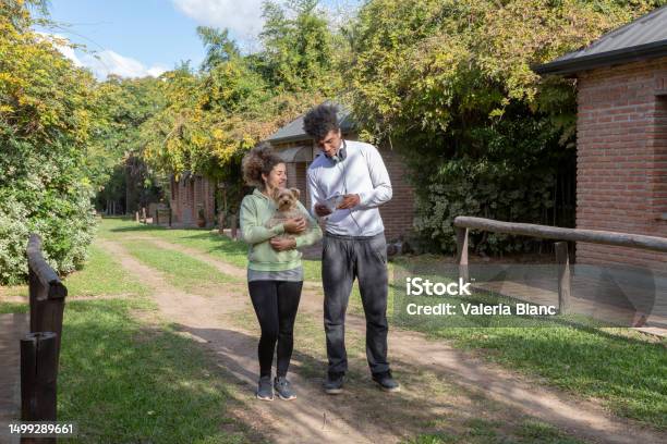 Couple With Pet Outdoors Stock Photo - Download Image Now - 20-24 Years, 30-34 Years, Active Lifestyle