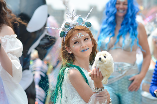 A young girl is seen marching in the Coney Island Mermaid Parade in Brooklyn, New York City on June 17, 2023.
