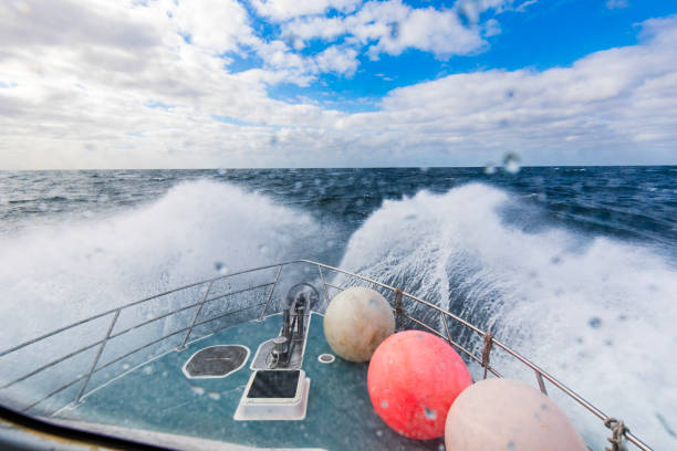 Travelling by boat across rough open ocean, view from captains cabin