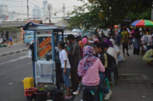 Jakarta is one of the most densely populated cities in the world. The train station is a place of community interaction. People travel from one place to another relying on public transportation such as trains. this causes the station is always crowded with people. This photo captures the condition of the train station in Jakarta.