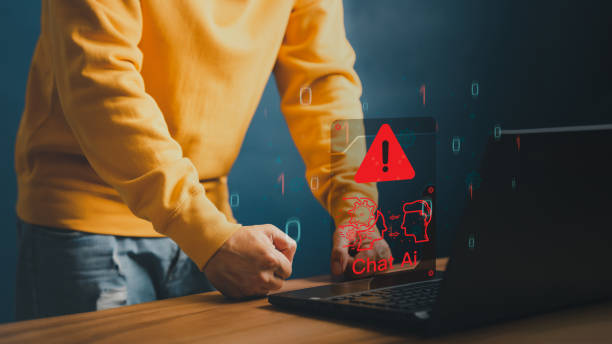istock AI with Chatbot, Artificial Intelligence. Adult man using laptop chatting with a smart AI using an artificial intelligence chatbot with triangle caution warning sign for notification error concept. 1499307809