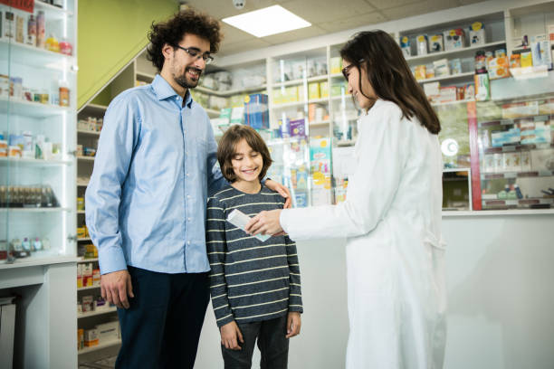 istock Asian pharmacist giving the advice to a man with a son 1499309409
