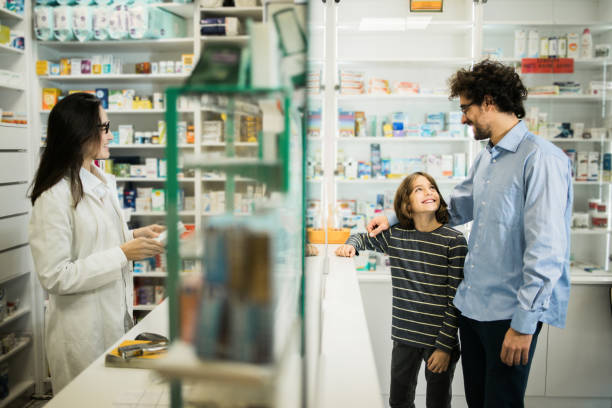 istock Female pharmacist advising a father with a son 1499309429
