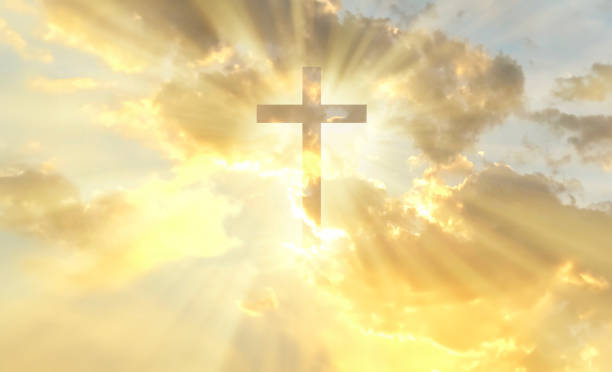 Christian cross appears bright in the gold sky Christian cross appears bright in the gold sky background christianity stock pictures, royalty-free photos & images