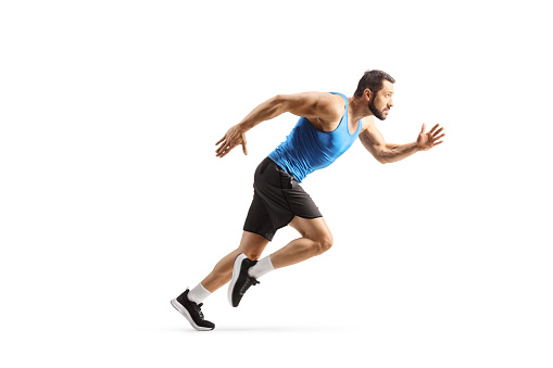 Sprinter. Caucasian professional male athlete, runner training isolated on white studio background. Muscular man. Concept of action, motion, youth, healthy lifestyle. Copyspace for ad. Side view