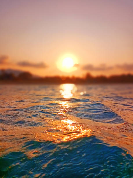 istock Sea wave splash, sunset blurred bokeh background, ocean water surf ripple texture, sunrise soft focus, tropical island beach dawn, sundown orange sun shine reflection, summer holiday, vacation, travel 1499329958