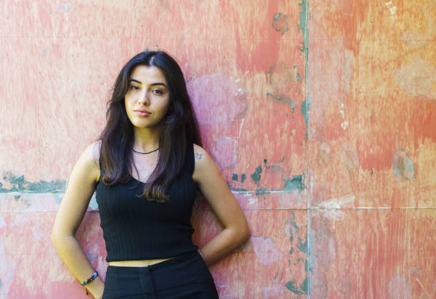 Confident young woman in casual clothings posing for camera
