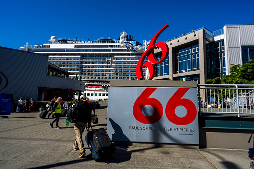 Seattle, Washington USA - June 3, 2023 : Early morning frenzied activity at Pier 66 as people prepare to board a ship for their Alaskan Cruise.