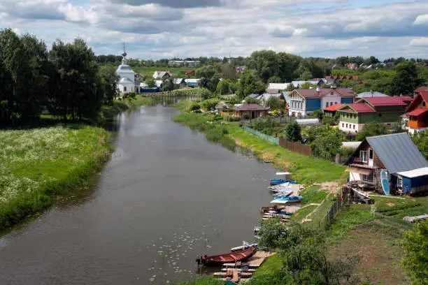 Panoramic view of the Kamenka River and the Church of the Epiphany of Christ (Epiphany Church) in Kozhevennaya Sloboda on a sunny summer day, Suzdal, Vladimir region, Russia