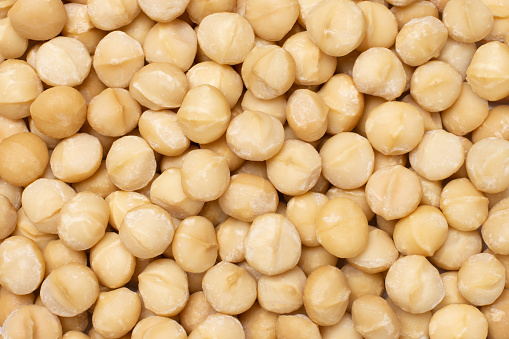 Macadamia nuts pattern texture background, top view, flat lay.