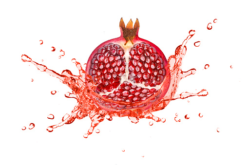 Red pomegranate juice splash isolated on white background.