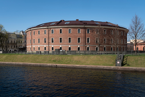 View of the former prison building on the island of New Holland on the bank of the Moika River on a sunny day, St. Petersburg, Russia