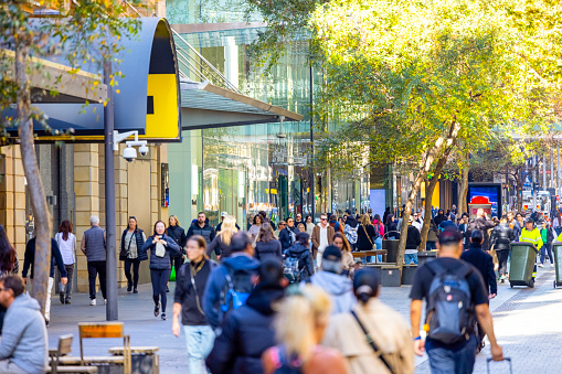 Crowd of People walking and enjoying sunny day in Pitt Street mall, Sydney Australia, full frame horizontal composition