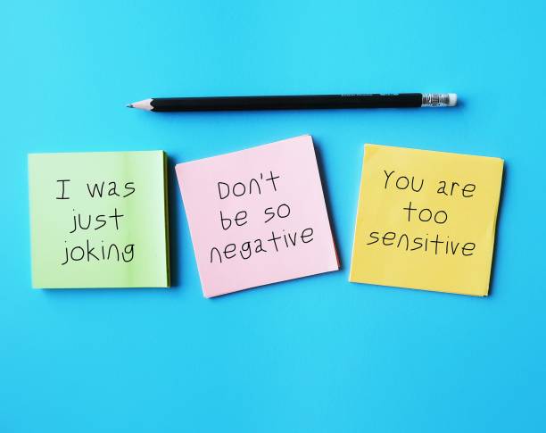 istock On blue background, notes with handwriting I WAS JUST JOKING, YOU'RE SO SENSITIVE and DON'T BE SO NEGATIVE, gaslighting verbal abuse use to manipulate and pin whole blame to victim 1499354350