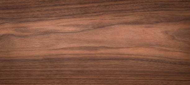 istock Walnut natural texture background. Extra long black walnut wood plank texture background.Wood texture background. 1499360495