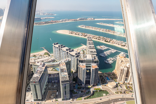Dubai, United Arab Emirates, March 18, 2023 : View from observation deck of the Nakheel Mall building to the Palm Jumeirah island in Dubai city, United Arab Emirates