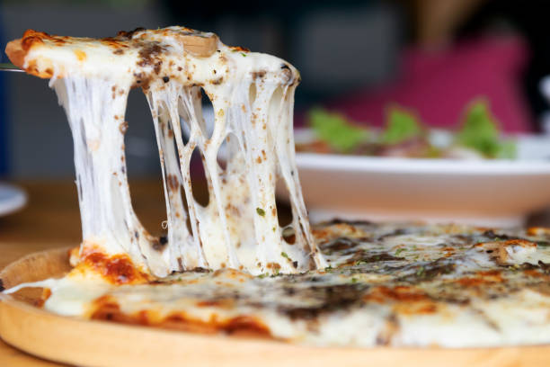 Pizza black truffle with cheese melting on wooden pizza plate.