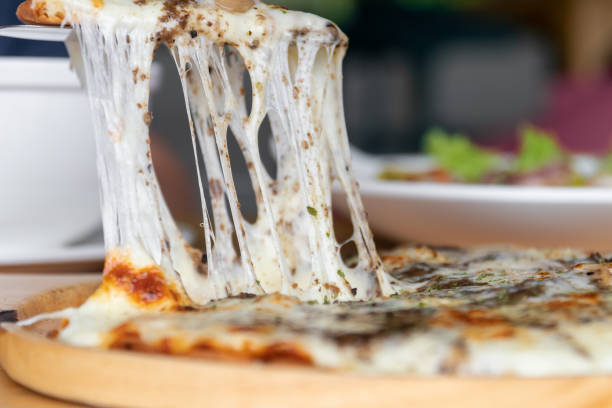 istock Pizza black truffle with cheese melting on wooden pizza plate. 1499362028