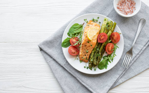 istock Baked Delicious salmon, green asparagus on  plate 1499366050
