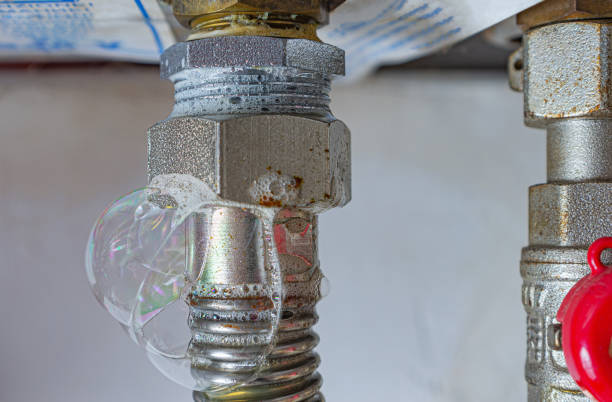 gas leak at home heating boiler. inflating bubbles of soap mixture applied to the threaded joint on the gas flexible pipe indicate a gas leak. - gas natural gas leaking sensor imagens e fotografias de stock