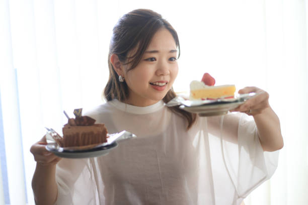 istock A woman wondering which cake to eat 1499371012