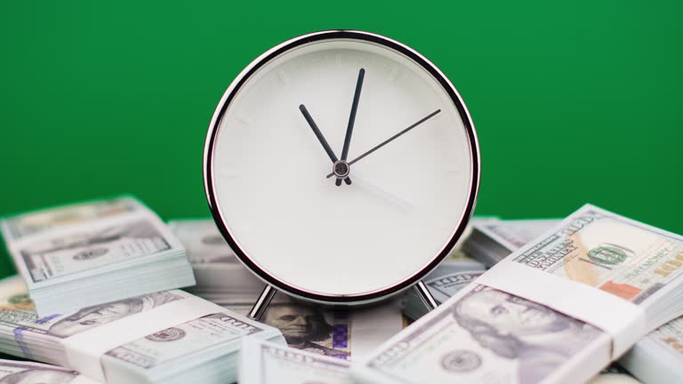 time and dollar Time lapse time spinning on a stack of dollars financial system financial planning financial system cash flow banking finance Dollar banknotes, saving money and investing money and time